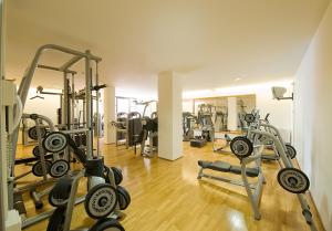 a gym with several treadmills and exercise bikes at La Reggia Sporting Center Hotel in Cascia