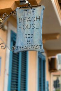 a sign that reads the beach house bed and breakfast at Taormina Beach House in Mazzeo
