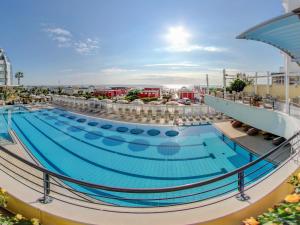 a large swimming pool on a cruise ship at Hotel Le Palme - Premier Resort in Milano Marittima