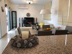 a kitchen and living room with a table and a couch at Marina View Villa 11 in Peyia