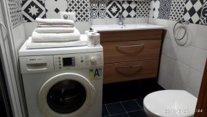 a bathroom with a washing machine and a sink at Archimede in Pavia