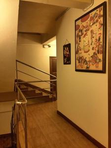 a hallway with a staircase and a painting on the wall at Chan Chiangmai House in Chiang Mai