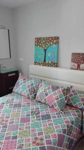 a bed with a quilt and pillows in a bedroom at Apartamento Vintage Benidorm in Benidorm