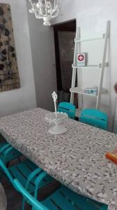a dining room table with blue chairs and a table with a table at Apartamento Vintage Benidorm in Benidorm
