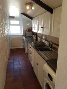 a kitchen with a sink and a counter top at The Cottage in Probus