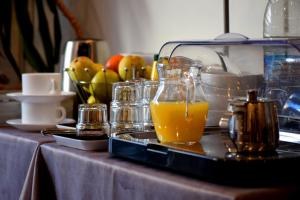 a tray with a glass of orange juice on a table at Nouvel Hotel in Saint-Raphaël