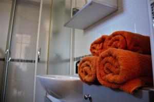 a pile of towels on a counter in a bathroom at Apartments Livun Tuheljske Toplice in Tuheljske Toplice +44 photos