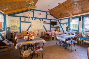 a dining room with blue walls and tables and chairs at Camping KamA in Mikołajki