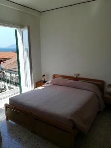 a bedroom with a bed and a large window at Albergo Calcagno in Borgio Verezzi