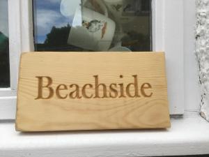 a sign in a window that reads beagle at Beachside - North Berwick in North Berwick