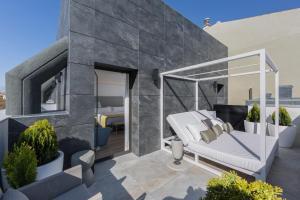 a balcony of a house with a bed at Catalonia Granada in Granada