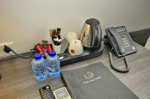 a desk with a phone and water bottles on it at Hotel Parkview in Amsterdam