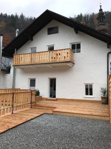 a large deck with a white house at Pension Kirchenwirt in Bad Ischl