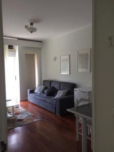 a living room with a couch and a table at Vale de Azereiros Apartamentos in Geres