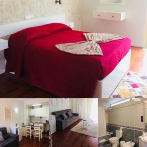 a bedroom with a red bed and a living room at Vale de Azereiros Apartamentos in Geres