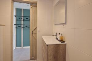 a bathroom with a sink and a shower at Studio 45D in Scheveningen