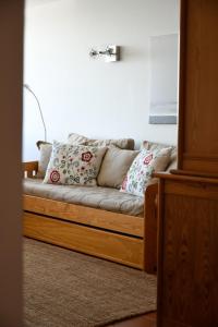 a couch with pillows on it in a living room at Marisol Apt Algarve in Armação de Pêra