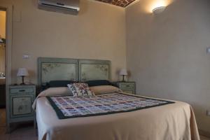 a bedroom with a bed and two night stands at Il Cenerino in Venaria Reale