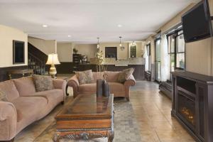 a living room with two couches and a fireplace at Travelodge by Wyndham Edmundston in Edmundston