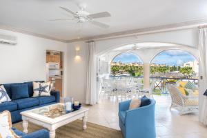 a living room with a blue couch and a table at Port St. Charles in Saint Peter