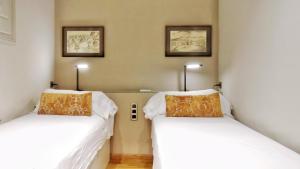 Posteľ alebo postele v izbe v ubytovaní BizFlats Eixample Apartments