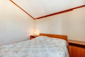 a bedroom with a bed and two night stands at Apartment Danilo in Mali Lošinj +3 photos