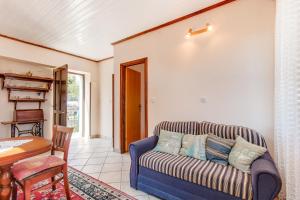 a living room with a couch and a table at Apartment Danilo in Mali Lošinj