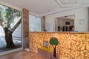 a wall with a mural of a tree on it at Villaggio Camping Odissea in Marina di Camerota
