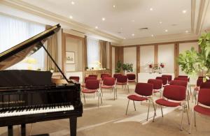 a room filled with furniture and a piano at Hôtel Bedford in Paris