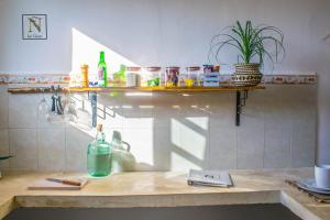 a kitchen with a counter with bottles on it at La Casa de Ñaña in Holbox Island