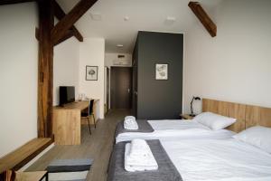 Postel nebo postele na pokoji v ubytování Arhiv Boutique House