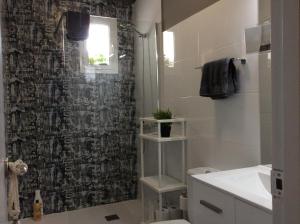 a bathroom with a black and white shower curtain at Sweet Home Alameda in Seville