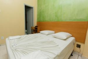 Cama ou camas em um quarto em Guanabara Hotel Centro Belo Horizonte