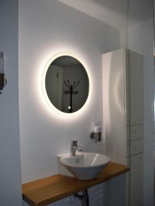 a bathroom with a sink and a mirror at Aan 't kapelke in Valkenburg
