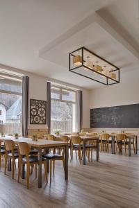 a classroom with tables and chairs and a chalkboard at Auberge La Douce Montagne in Allemont