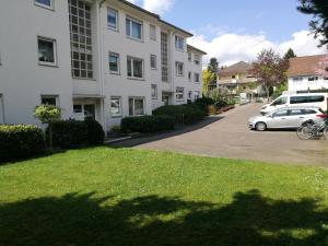a car parked in a parking lot next to a building at Haus - Bonsai Bonsai Apartments I in Bad Pyrmont