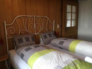 a bed with a metal headboard and two pillows at Appartement Fernsicht Triesenberg in Triesenberg