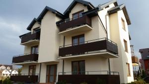 a building with balconies on the side of it at Wysoka Fala in Jastrzębia Góra