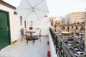 a balcony with a table and a view of a city at Il Tempo Ritrovato - Locazione ad uso turistico in Palermo