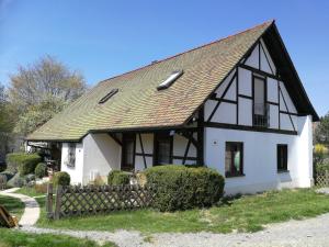 a white and black house with a black roof at Ferienwohnung am Bodensee Heiligenberg in Heiligenberg