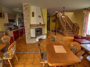 a kitchen and living room with a table and chairs at Vila Veronika in Lednice