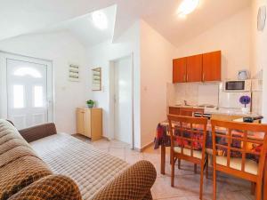 a living room with a couch and a table and a kitchen at Maki Apartments - Plavi Horizonti Beach in Tivat