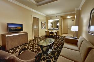a living room with a couch and a tv at Hollywood Casino St. Louis in Maryland Heights