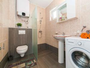 a bathroom with a washing machine and a sink at Maki Apartments - Plavi Horizonti Beach in Tivat +68 photos