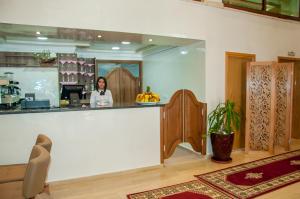 eine Frau, die hinter einem Tresen in einem Raum steht in der Unterkunft Sania Hotel in Sidi Bennour