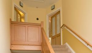 a wooden staircase leading up to a room with a wooden floor at Poplar House Serviced Apartments in York