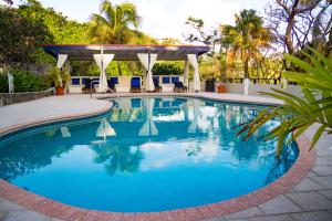 a swimming pool with a gazebo and blue water at Blue Lagoon Hotel and Marina Ltd in Kingstown