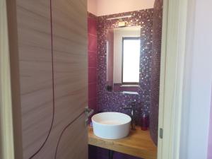 a bathroom with a sink and a mirror at Attico Sole Luna in Taormina