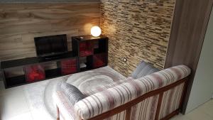 a living room with a couch and a television at O Ninho in Vila Nova de Gaia