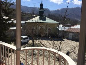 a view from a balcony of a church with a clock tower at Lahic Hostel in Lahıc